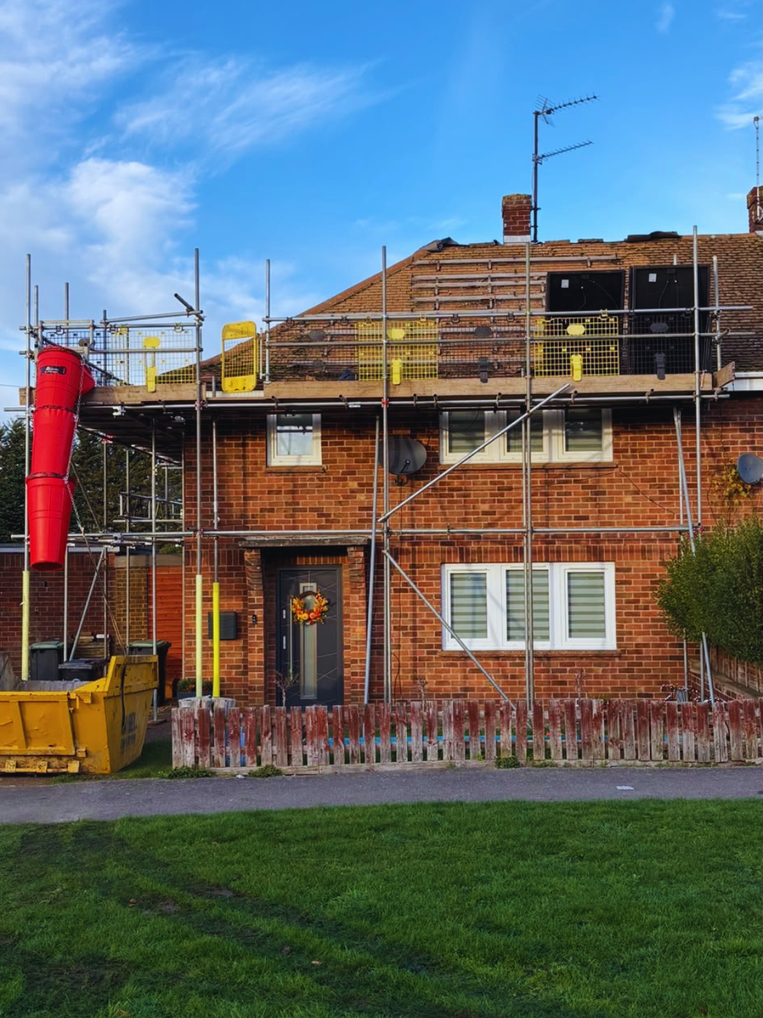Roof scaffolding with debris chute to a semi-detached house