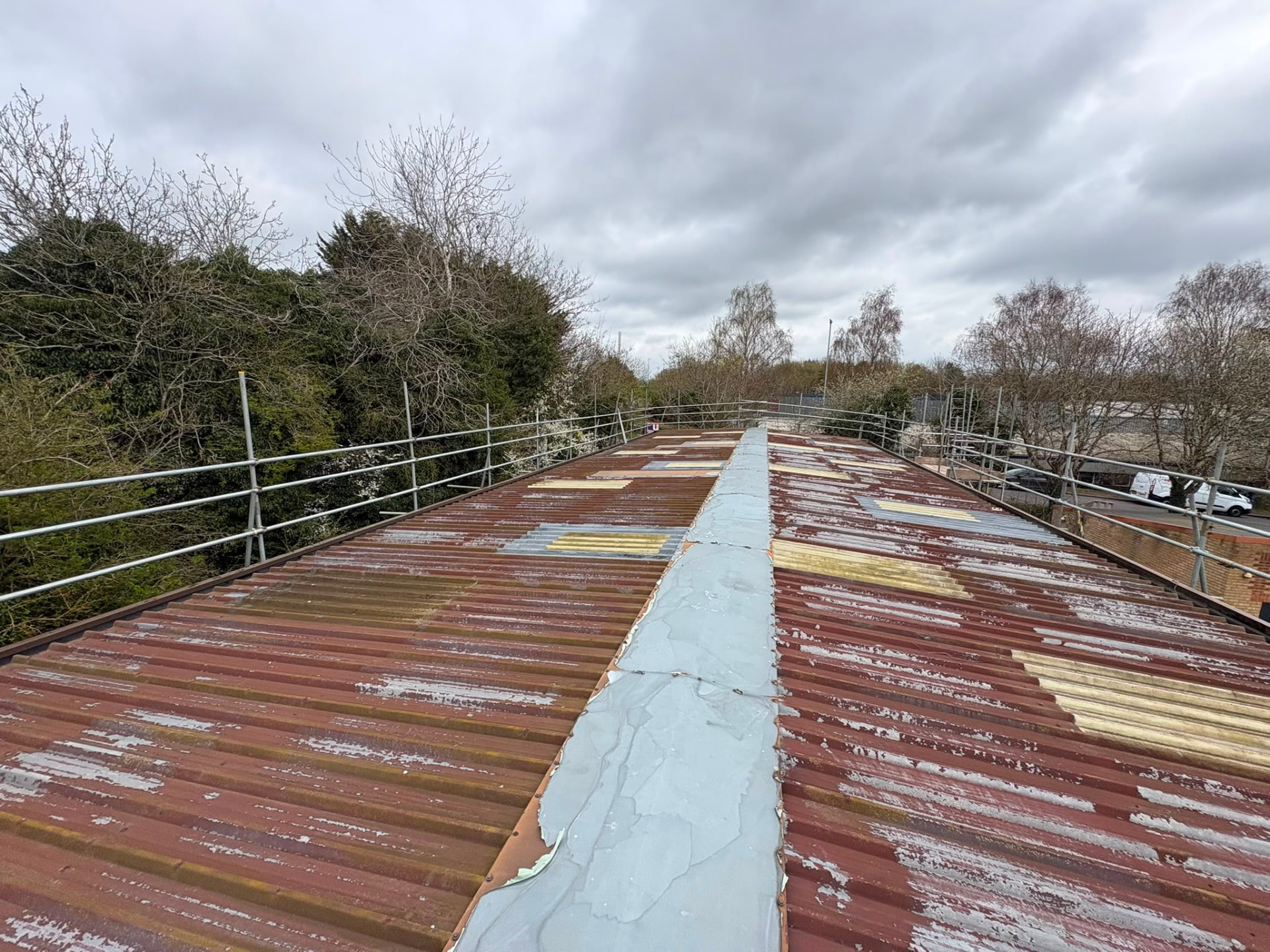Roof level view of edge protection guardrails around an industrial roof