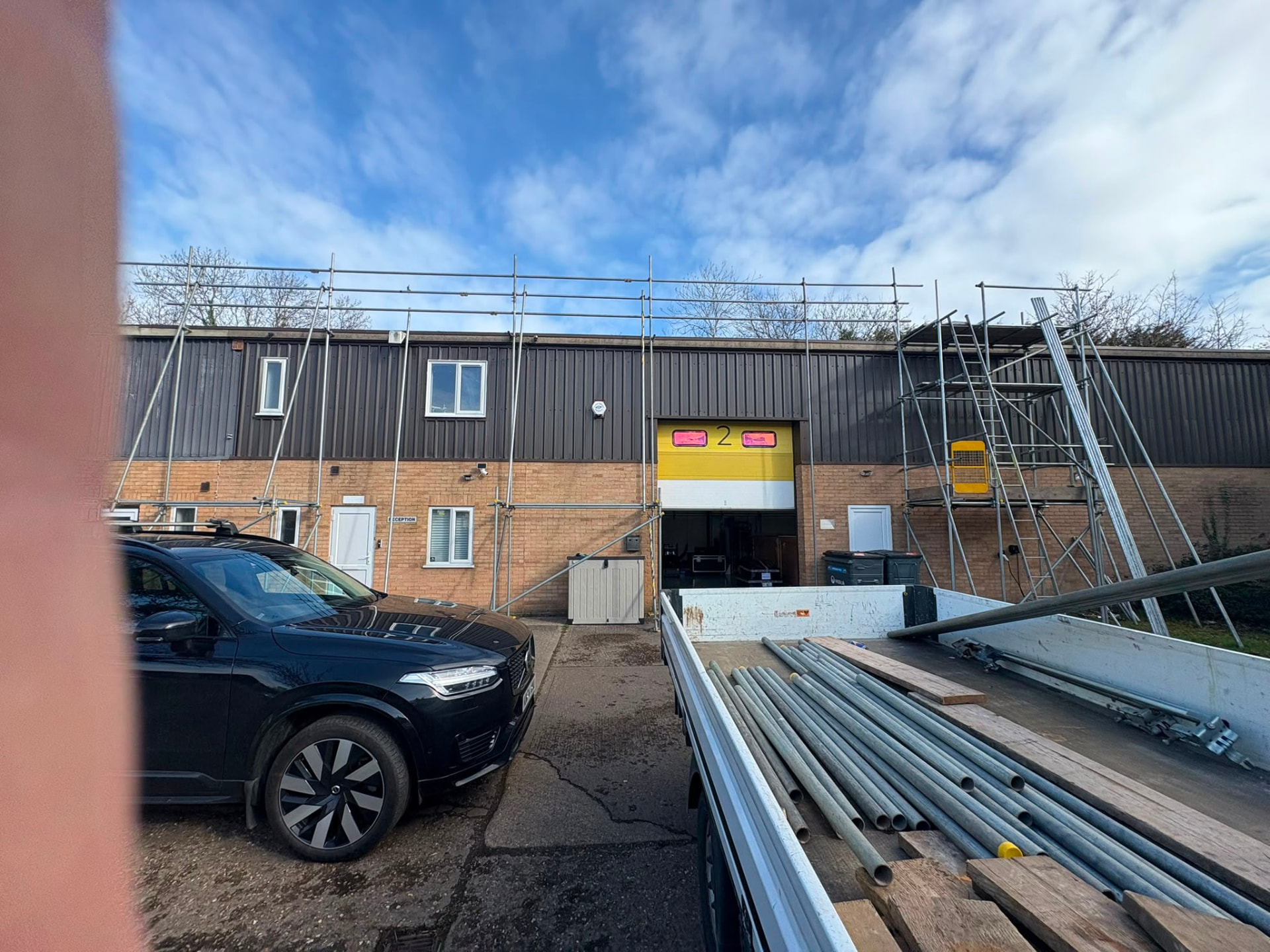 Edge protection scaffolding to an industrial unit with materials being loaded from our lorry