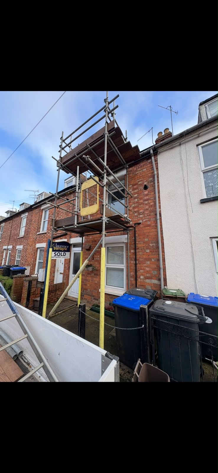 Two lift tower scaffold to the front of a red brick terraced house