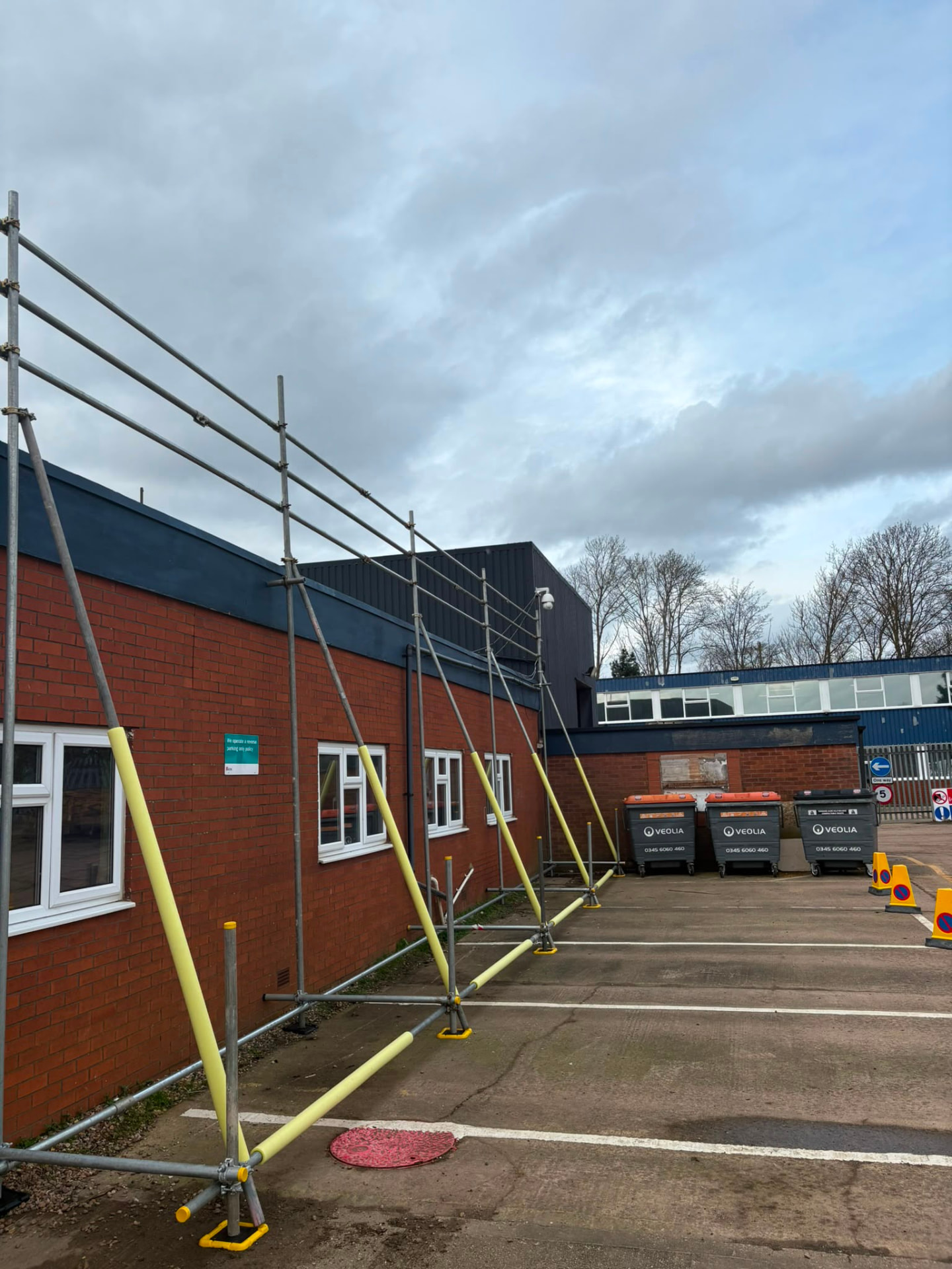 Edge protection guardrails along the perimeter of a flat roof industrial building